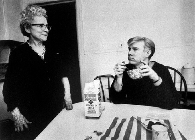 Andy Warhol eating cereal with his mother. 