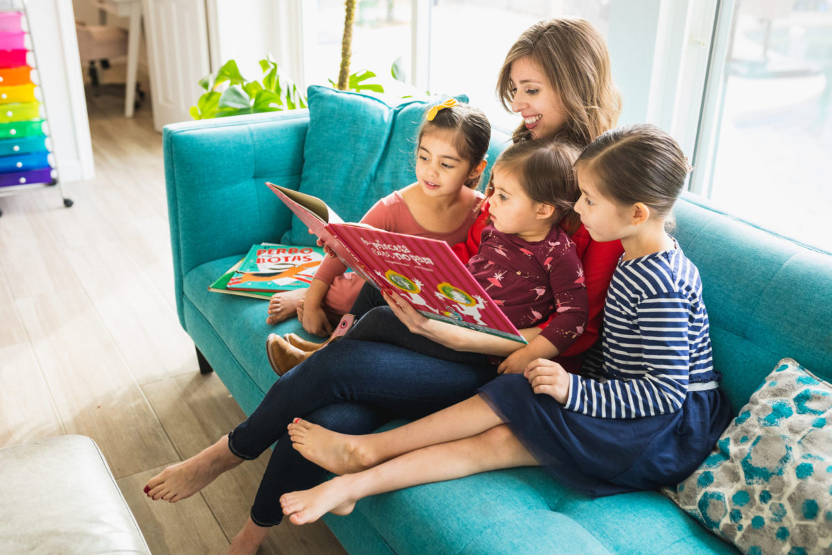 Mom reading to her three daughters.